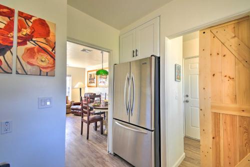 a kitchen with a stainless steel refrigerator and a dining room at Pet-Friendly Phoenix Home Breezeway and Fenced Yard in Phoenix