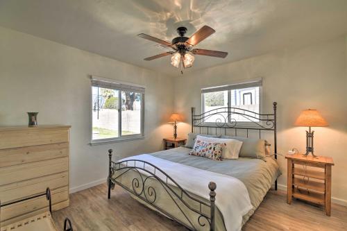 a bedroom with a bed with a ceiling fan at Pet-Friendly Phoenix Home with Breezeway and Fire Pit! in Phoenix