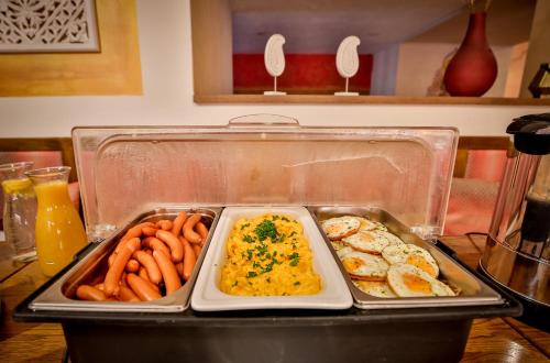 a tray of food with eggs and carrots on a table at Hotel Tábor in Tábor
