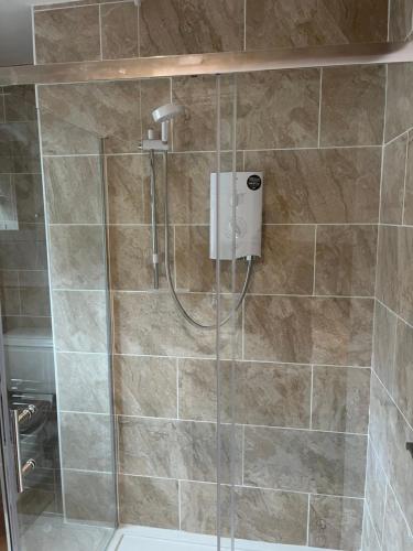 a bathroom with a shower with a glass door at Jasmine House in Newquay