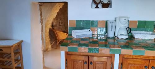 a kitchen with a counter with a tile counter top at La Campagne Saint Jean in Baudinard