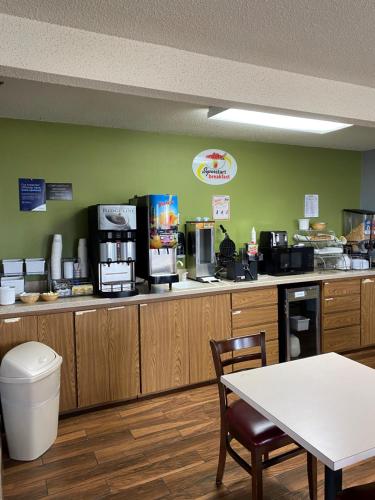 a fast food kitchen with a table and a counter at Super 8 by Wyndham Toledo in Toledo