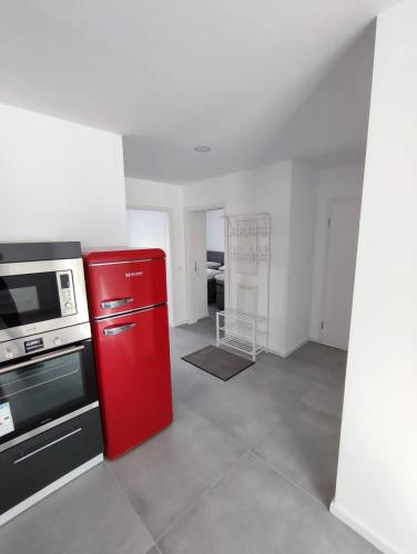 a kitchen with a red refrigerator and a stove at Ferienwohnungen am Stadtgarten Pforzheim in Pforzheim