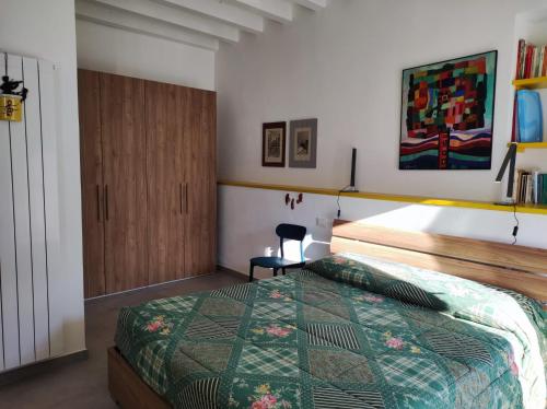 a bedroom with a bed and a chair in it at Casa dei giuggioli in Vernazza