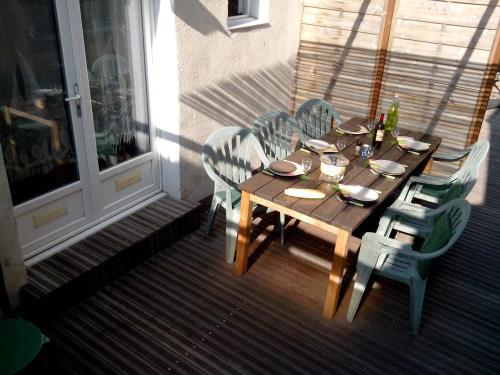 a wooden table and chairs sitting on a porch at Cabanon du Pêcheur, Parc National des Calanques in Marseille