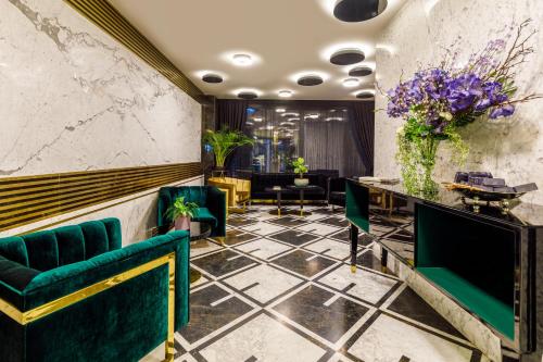 a lobby with green chairs and a table with flowers at Euro Design Hotel in Istanbul