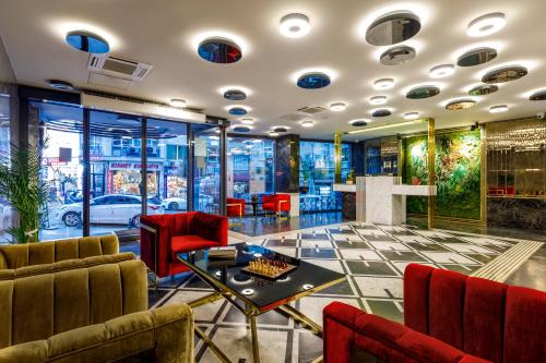 a lobby with red chairs and a table at Euro Design Hotel in Istanbul