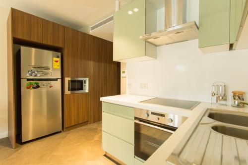 a kitchen with a stainless steel refrigerator and a sink at Accra Luxury Apartments @ Pearl in Accra