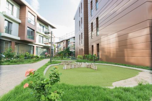 a courtyard with a circle of chairs on the grass at Accra Luxury Apartments @ Pearl in Accra