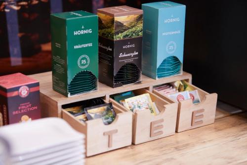 a wooden shelf with boxes of food on a table at I AM HOTEL Graz-Seiersberg in Graz