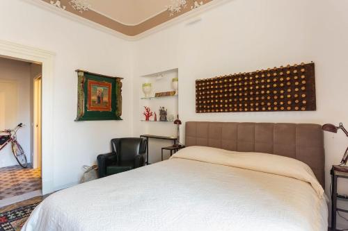 een slaapkamer met een bed en een stoel bij Sicilianinsta Rooms in Catania