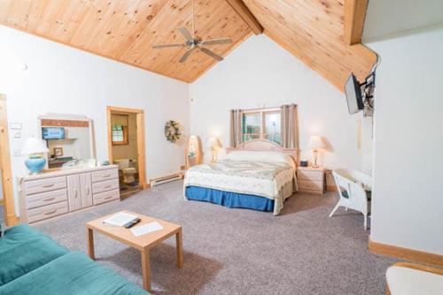 a bedroom with a bed and a couch and a table at Morning Glory Inn in Slaty Fork