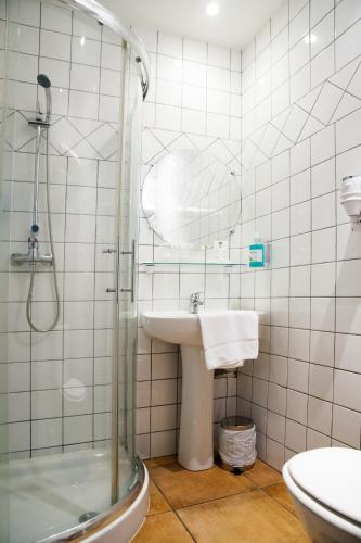 a bathroom with a sink and a shower at Splendid Hôtel in LʼÎle-Rousse