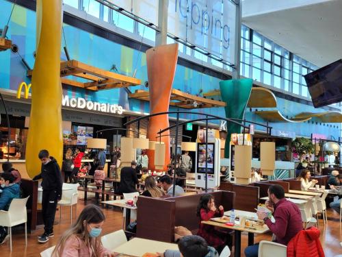 a group of people sitting at tables in a mall at Portus Vita Apartamento T0 Duplex in Vila Nova de Gaia