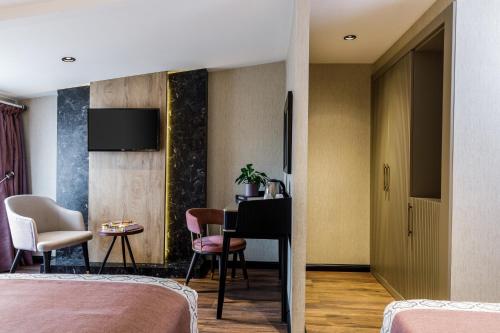 a hotel room with two beds and a desk at Euro Design Hotel in Istanbul