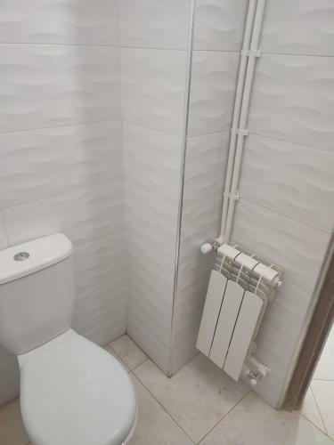 a white bathroom with a toilet and a shower at The good stay 1midelt in Midelt