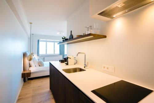 a kitchen with a sink and a counter top at Hotel du Bassin in Ostend
