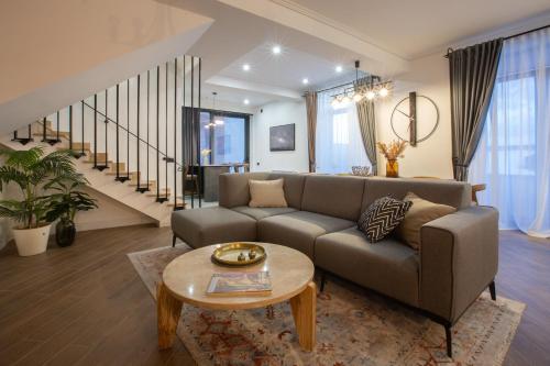 a living room with a couch and a table at Luxury Cottage in Tsaghkadzor by Downtown Inn in Tsaghkadzor