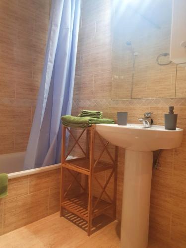 a bathroom with a sink and a shower and a tub at Apartaments Flamingo in L'Ampolla