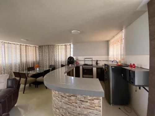 uma cozinha e sala de estar com uma grande bancada em TACNA APART em Tacna