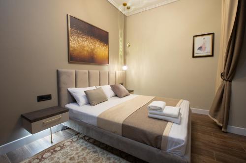 a bedroom with a large bed with two towels on it at Luxury Cottage in Tsaghkadzor by Downtown Inn in Tsaghkadzor