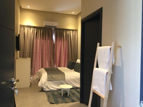 a small bedroom with a bed and a window at Villa Jamila -Villa de luxe a Marrakech in Marrakesh