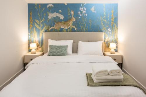 a bedroom with a bed with a painting of a deer at Luxury Cottage in Tsaghkadzor by Downtown Inn in Tsaghkadzor