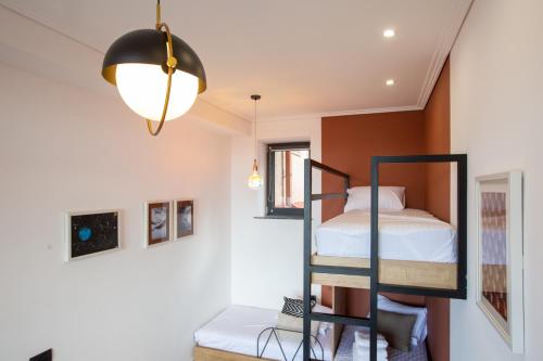 a bedroom with a bunk bed and a lamp at Luxury Cottage in Tsaghkadzor by Downtown Inn in Tsaghkadzor