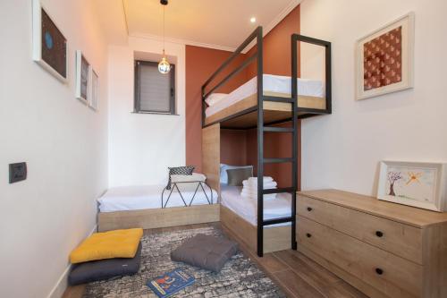 a small room with bunk beds and a desk at Luxury Cottage in Tsaghkadzor by Downtown Inn in Tsaghkadzor