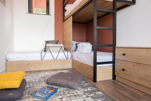 a bedroom with a bunk bed with a ladder at Luxury Cottage in Tsaghkadzor by Downtown Inn in Tsaghkadzor