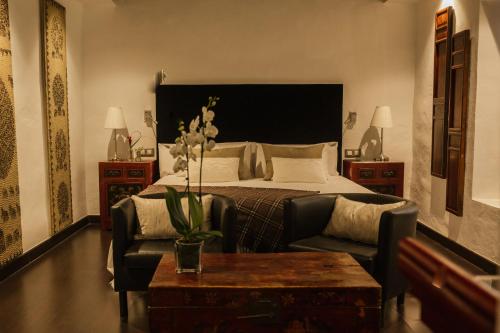 a bedroom with a bed and a couch and a table at HC6 Boutique Marbella - Adults Only in Marbella