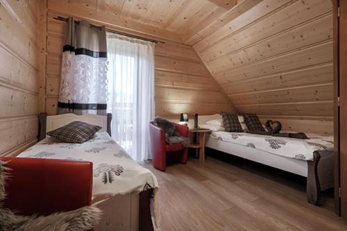 מיטה או מיטות בחדר ב-Willa Dream z basenem i jacuzzi