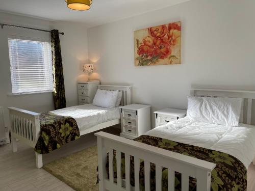 מיטה או מיטות בחדר ב-No2 at Rosebank Apartments
