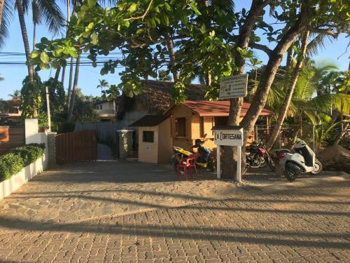 a group of motorcycles parked in front of a house at La Cortesana Cozy Two Bedroom Apartment Steps to the Beach in Las Terrenas