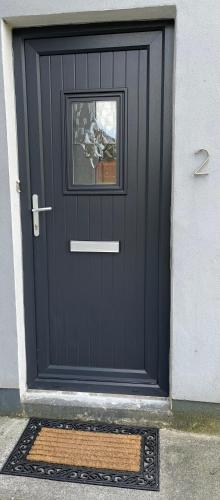 a black garage door with a window on it at No2 at Rosebank Apartments in Moville