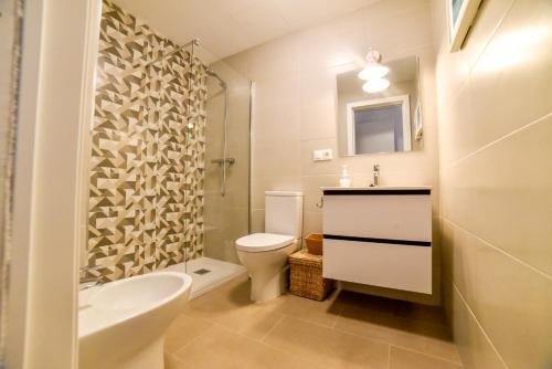 a bathroom with a toilet and a sink and a shower at Your Home in Seville in Seville