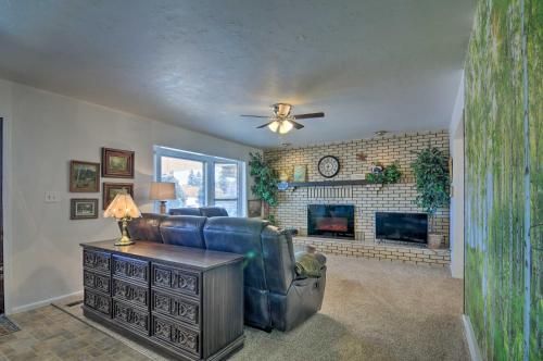 a living room with a couch and a fireplace at Bryce Canyon Area House with Mountain Views! in Tropic
