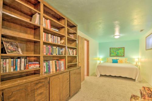 a bedroom with a bed and book shelves with books at Bryce Canyon Area House with Mountain Views! in Tropic
