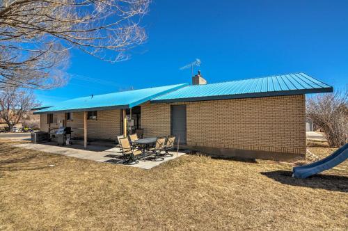 a small brick building with a blue roof at Bryce Canyon Area House with Mountain Views! in Tropic