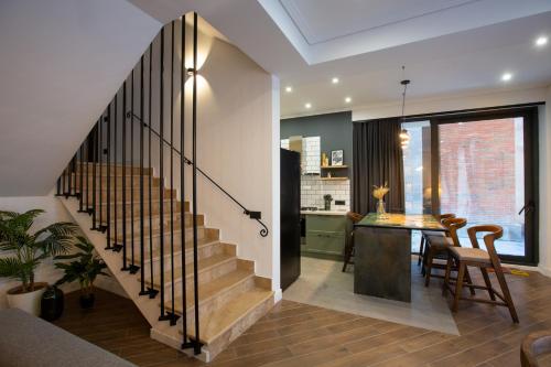 a staircase in a home with a dining room and kitchen at Luxury Cottage in Tsaghkadzor by Downtown Inn in Tsaghkadzor