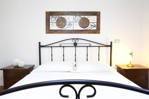a bedroom with a large bed with a black frame at Macri Alghero in Alghero