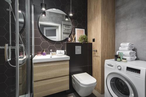 ein Badezimmer mit Waschmaschine und Waschmaschine in der Unterkunft TS New Town Apartments in Stettin