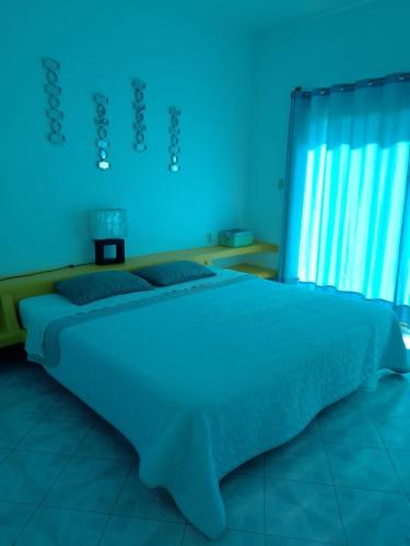 Una cama o camas en una habitación de Residencia Jacarandas