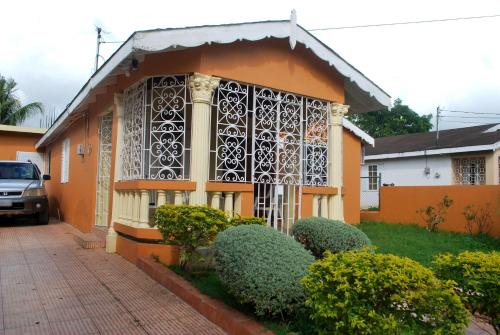 a house with a gate on the front of it at Alian's Comfort Stay in Montego Bay