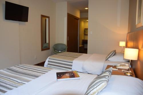 Letto o letti in una camera di Augusto's Rio Copa Hotel