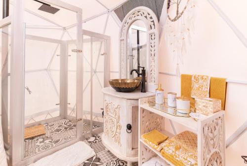 uma casa de banho com um lavatório e um espelho em La Colina Glamping em La Vega