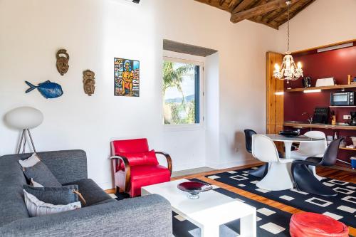 a living room with a couch and a table at Casa do Pico Arde in Ribeira Grande