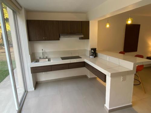 a kitchen with a white counter and a sink at Hotel Marjaba in Cuernavaca