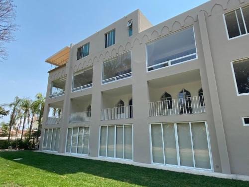a large white building with large windows at Hotel Marjaba in Cuernavaca