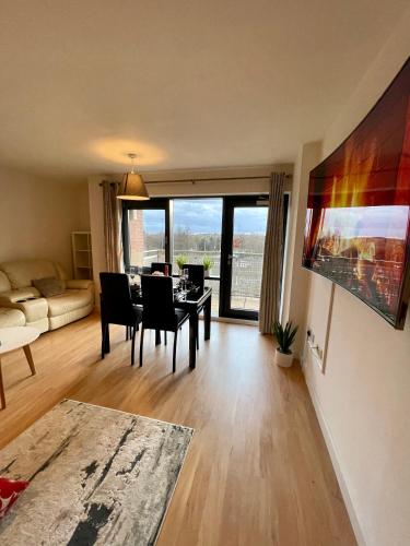 a living room with a table and chairs and a couch at Empire Serviced Apartments in Leicester